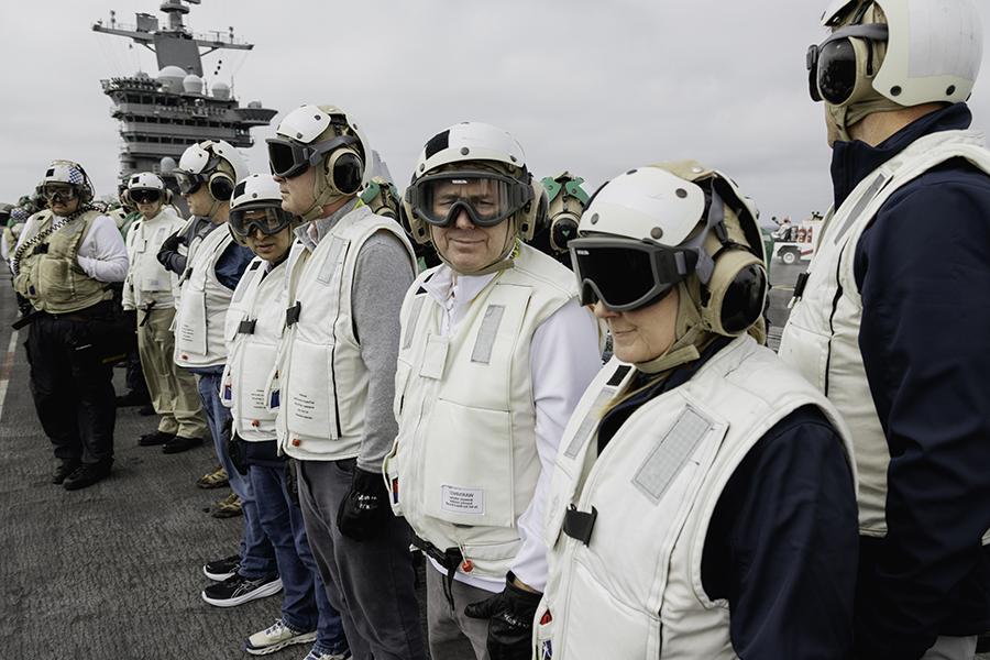 Northwest President Dr. Lance Tatum (center) observed flight operations on the USS George Washington flight deck and interacted with its sailors.